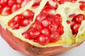 Half of pomegranate closeup on a white background