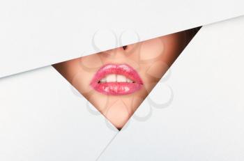 Beautiful female lips closeup behind silver metal background