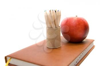 Back to school concept with book and apple and pencils