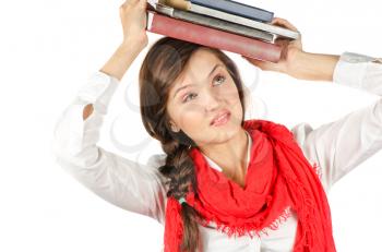 Young student girl with her books in hand at head, smiling and looking at the camera
