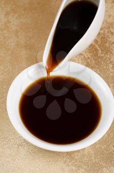soy sauce poured to a white plate