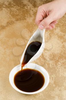 Female woman pouring soy sauce