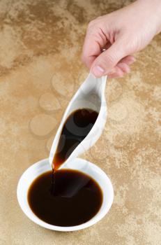 soy sauce poured on a white