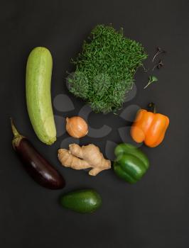 Fresh vegetables and micro greens sprouts on black background. Concept of superfood and healthy organic food
