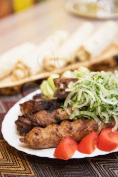 Grilled shish kebab or shashlik meat with vegetables