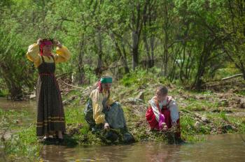 TOPOLNOE, ALTAY, RUSSIA - May 27, 2018: Folk festivities dedicated to the feast of the Holy Trinity. Ancient Russian rite: girls are sinking their birch wreaths