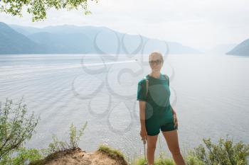Woman on Teletskoye lake in Altai mountains, Siberia, Russia. Beauty summer day.