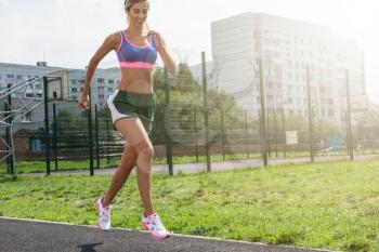 A young beauty athletic woman in sportswear running at outdoor early morning. Healthy lifestyle.