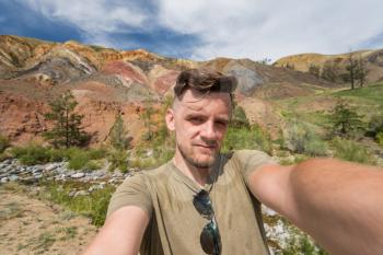 Selfie of young man in Altai mountain, beauty summer landcape