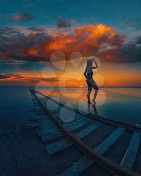 Woman at beauty sunset on salty lake