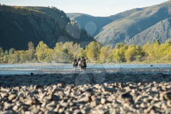 CHARISHSKOE. ALTAISKIY KRAI. WESTERN SIBERIA. RUSSIA - SEPTEMBER 15, 2016: descendants of the Cossacks in the Altai, cossack rides a horse on the Charish river on September 15, 2016 in Altayskiy krai, Siberia, Russia.