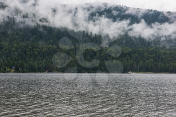Teletskoye lake in Altai mountains, Siberia, Russia. Foggy summer morning.
