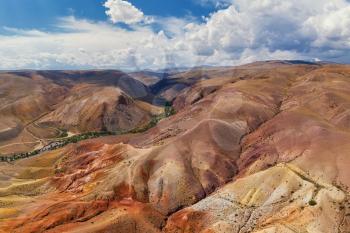 Aerial drone panorama of colorful eroded landform of Altai mountains with yellow, brown and red colors. Nature landscape in popular tourist location called Mars, near the border with Mongolia, Chagan-Uzun, Altai Republic, Russia