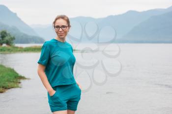 Woman on Teletskoye lake in Altai mountains, Siberia, Russia. Beauty summer day.