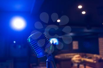 Retro music microphone on stage in a night club. Show or performance concept