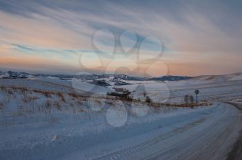 Altai mountains winter road through mountains pass, early morning before sunrise