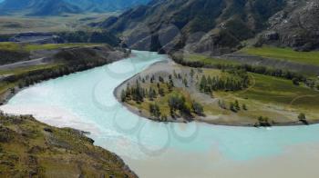 The confluence of two rivers, Katun and Chuya, the famous tourist spot in the Altai mountains, Siberia, Russia, aerial shot.