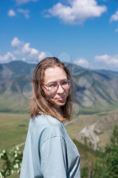 Travel, leisure and freedom concept - woman portrait in Altai mountains, beauty summer day