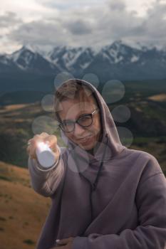 Woman with flashlight in summer Altai mountains in Kurai steppe