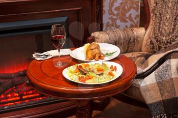 Dinner at table and on fireplace background