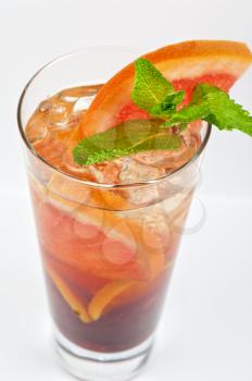 cold tea with grapefruit, lime, mint and ice on white