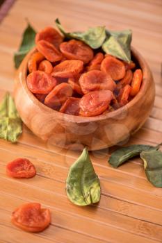 Dried apricots in a wooden bowl