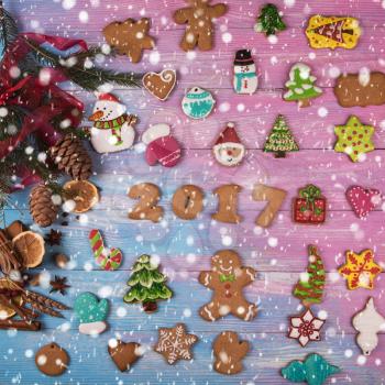 Gingerbreads for new 2017 year holiday on wooden background, xmas theme