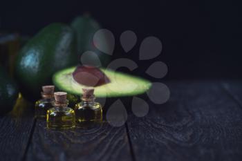 Oil of avocado on a dark wooden background