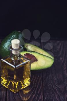 Oil of avocado on a dark wooden background