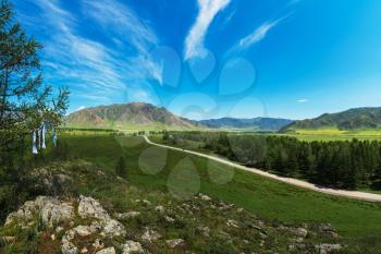 Rural road in mountains in Karakol valley, Altay, Siberia, Russia