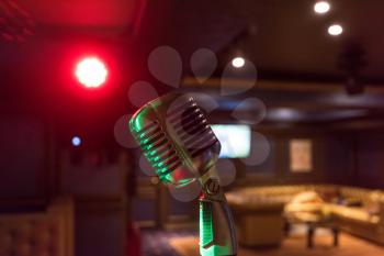 Retro music microphone on stage in a night club. Show or performance concept