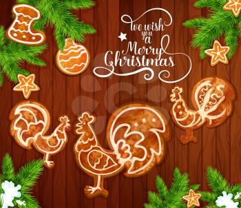 Christmas Day greeting card with xmas tree branches and gingerbread on wooden background. Ginger cookie in shape of chinese zodiac rooster, star and sock with snowy pine tree. New Year poster design