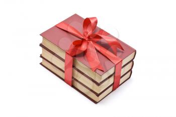 Pile of books with red ribbon and bow 