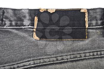 Royalty Free Photo of a Torn Label on Blue Jeans