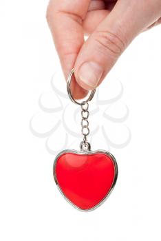 Royalty Free Photo of a Persons Hand Holding a Heart Shaped Keychain