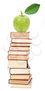 Stack of books and green apple