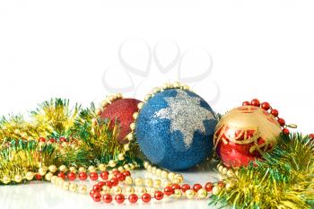 Christmas is coming. Decoration - colorful tinsel and balls over white background