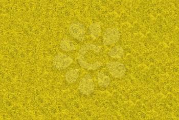 Close-up of yellow synthetic fibrous surface useful as background