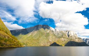 Mountains and fiords -  norwegian landscape. Clouds and blue sky