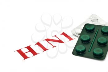 Swine FLU H1N1 - Closeup of green and white pills over white