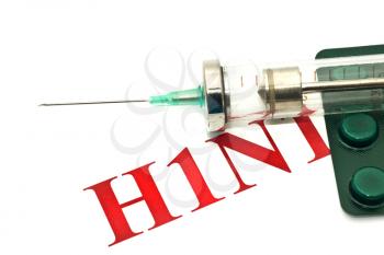 Swine FLU H1N1 disease warning - pills and syringe over white 
