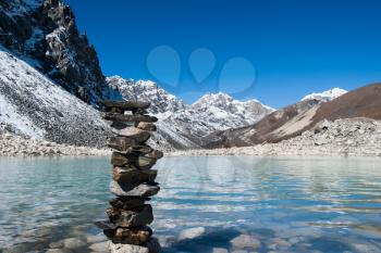 Harmony: Stone stack and Sacred Gokyo Lake. Travel to Nepal