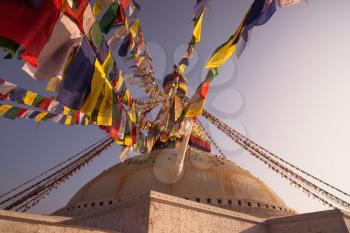 Colorful Prayer flags and Boudhanath stupa in Kathmandu. buddhism and religion