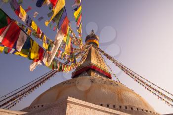 Prayer flags and Boudhanath stupa in Kathmandu. buddhism and religion