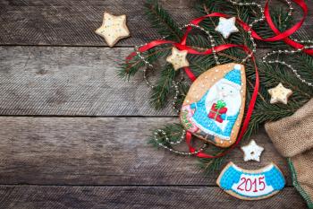 Christmas Santa in blue and New Year star cookies in rustic style on wood. Free space for text
