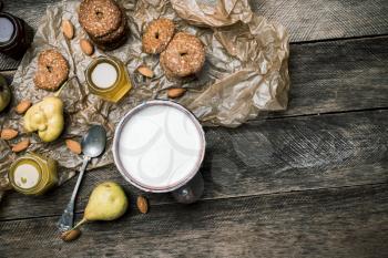 ears Cookies Almonds and milk on wooden table. Rustic style and autumn food photo