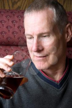 Royalty Free Photo of a Man About to Drink a Dark Beer