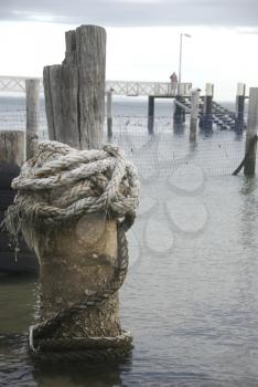 Royalty Free Photo of a Mooring Rope Around a Post
