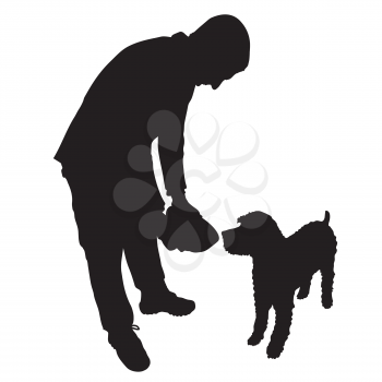 A man is about to feed a dog some food or water from a bowl