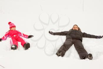 Royalty Free Photo of a Brother and Sister Making Snow Angels